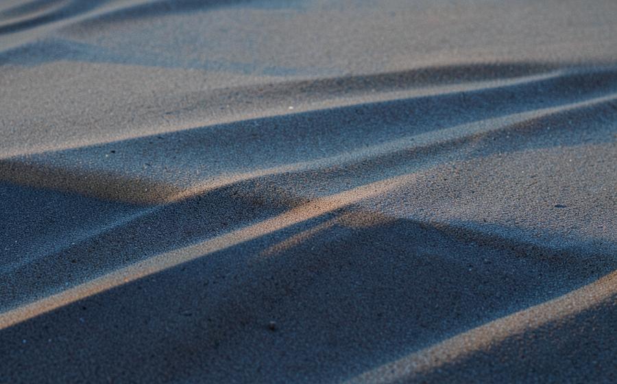 Layered sand and stone textures in muted natural colors