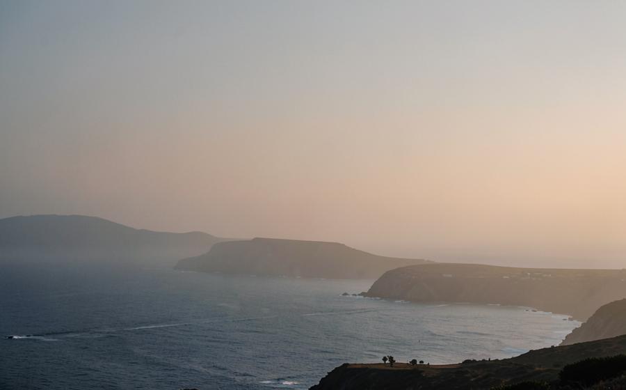 A quiet coastal horizon softened by haze